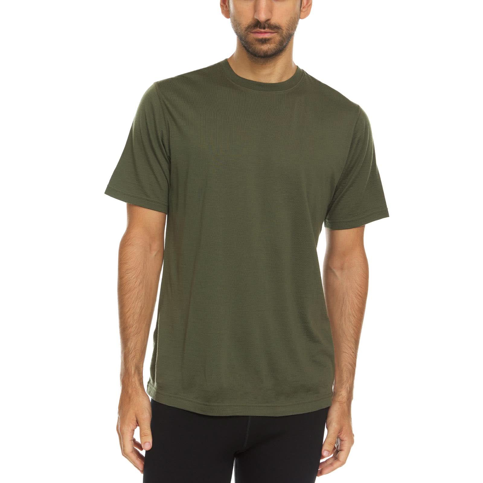 A man wearing an olive drab green 100 percent merino wool t shirt shown from the waist up against a solid white background.