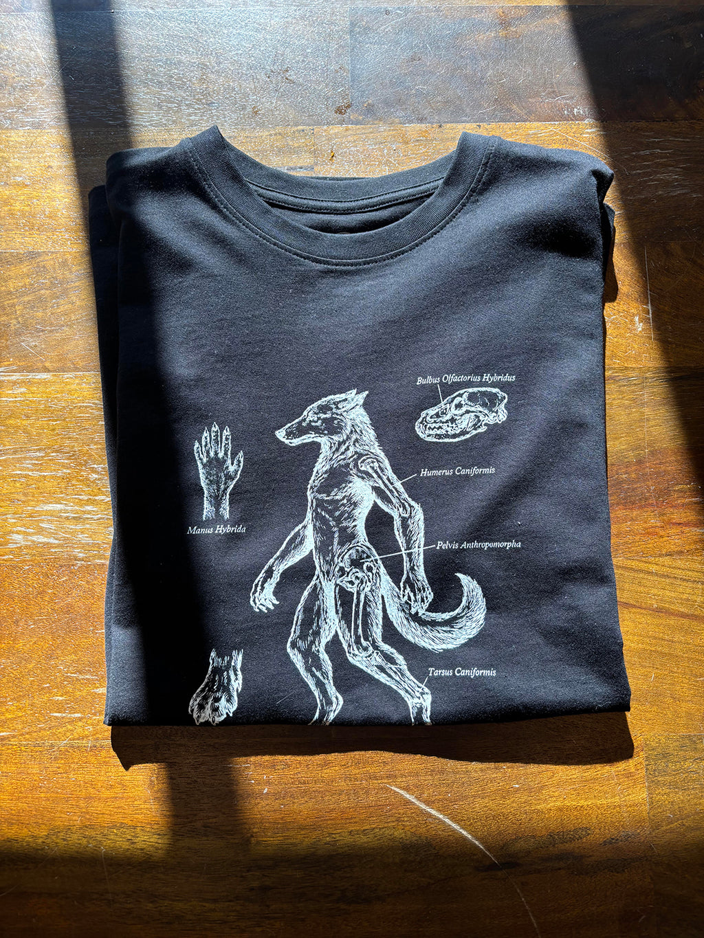 black all cotton heavyweight graphic tee with white drawing of hybrid man-dog