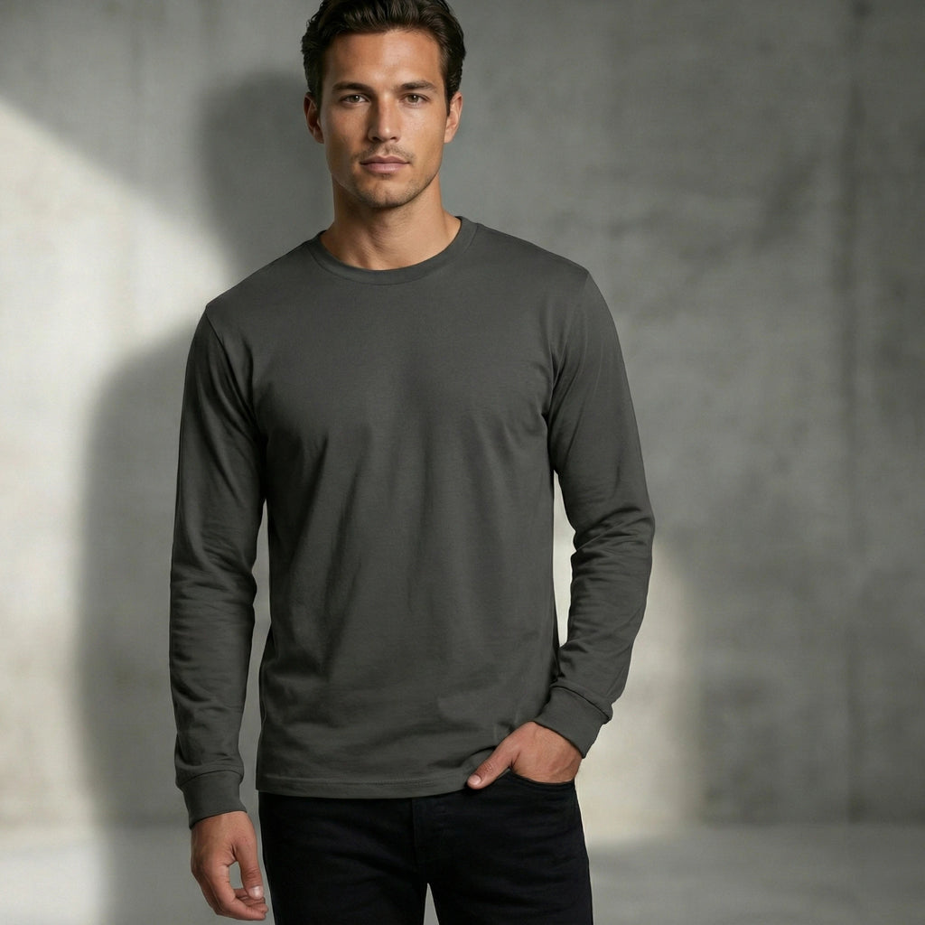 Man wearing a dark gray 185gsm ring-spun organic cotton long-sleeve shirt against a neutral background