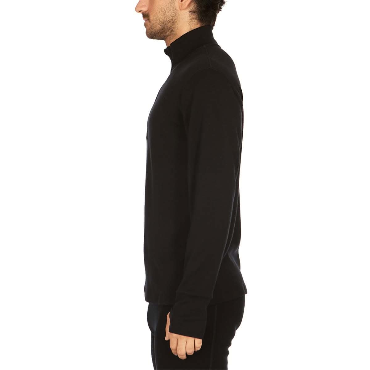 A man wearing a black 100 percent merino wool athletic quarter zip shown from the side against a solid white background.