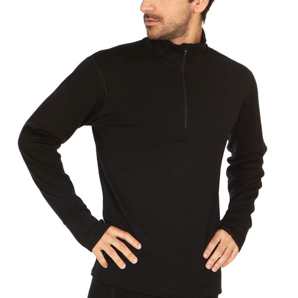 A man wearing a black 100 percent merino wool athletic quarter zip with hands on hips shown at an angle against a solid white background.