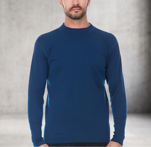 A man wearing a blue 100 percent merino wool mock neck shown from the waist up against a textured grey background.