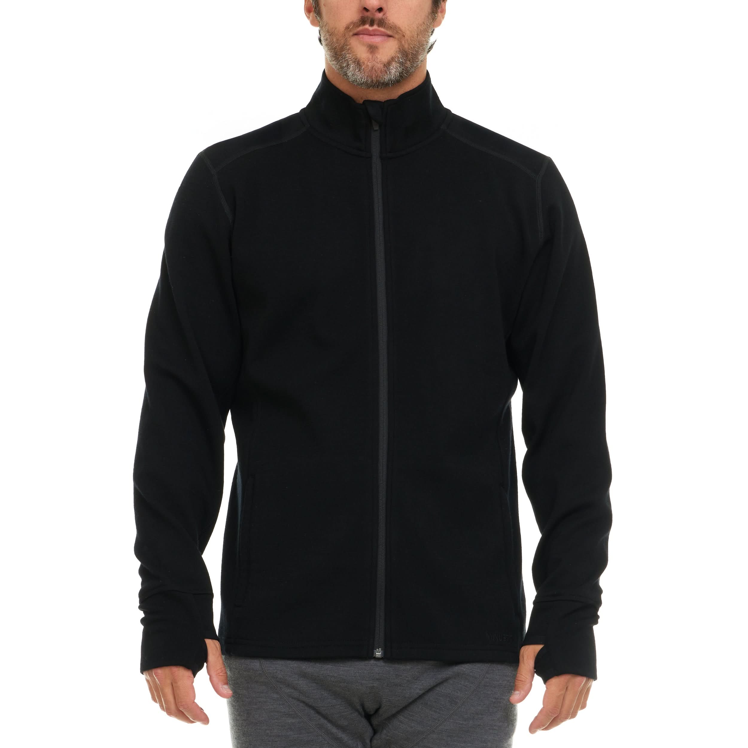 A bearded man wearing a black 100 percent merino wool full zip sweater shown from the waist up against a solid white background.