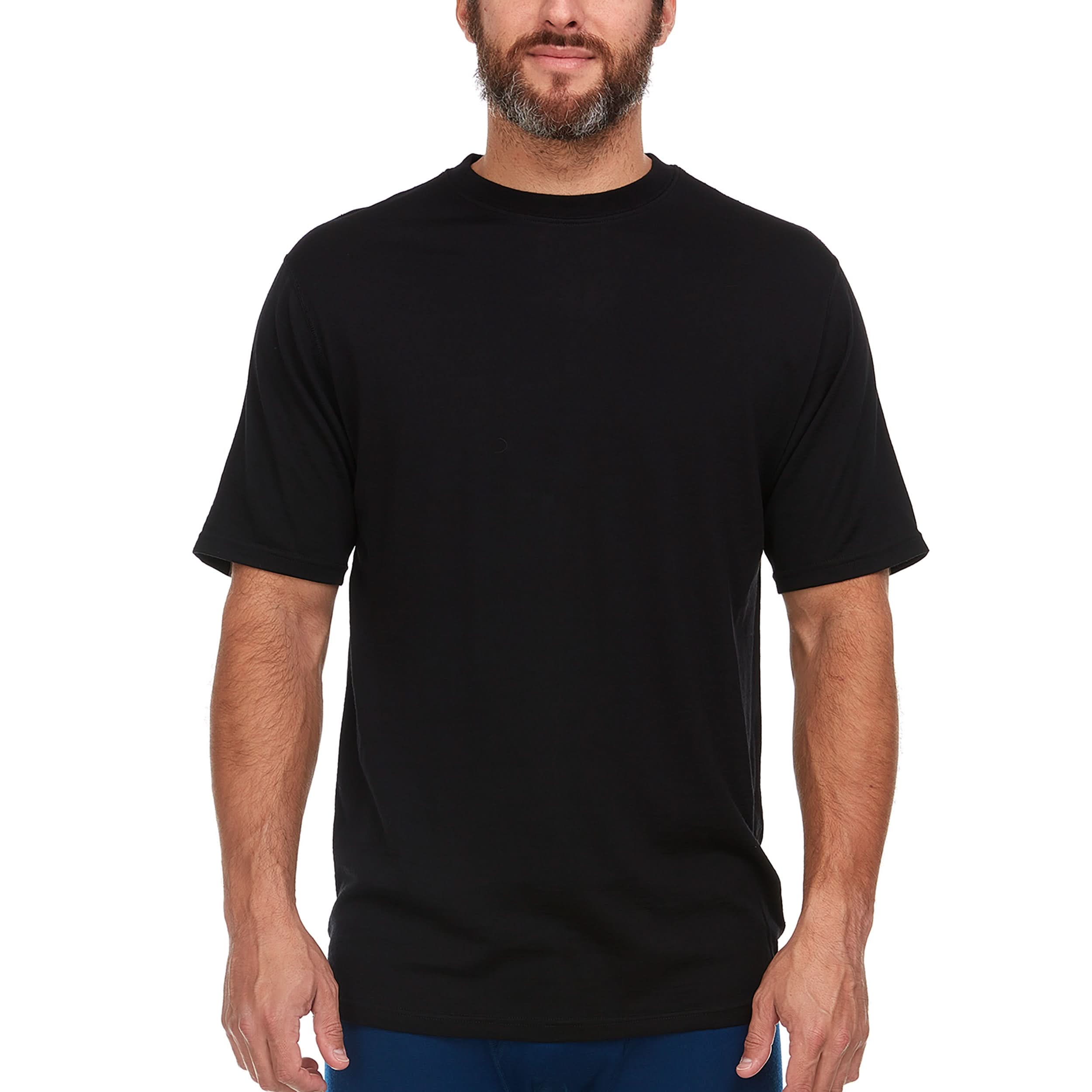 A man wearing a black 100 percent merino wool t shirt shown from the waist up against a solid white background.