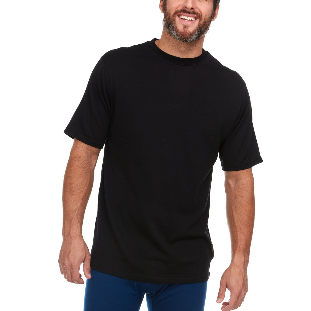 A man wearing a black 100 percent merino wool t shirt shown at a three-quarter angle against a solid white background.