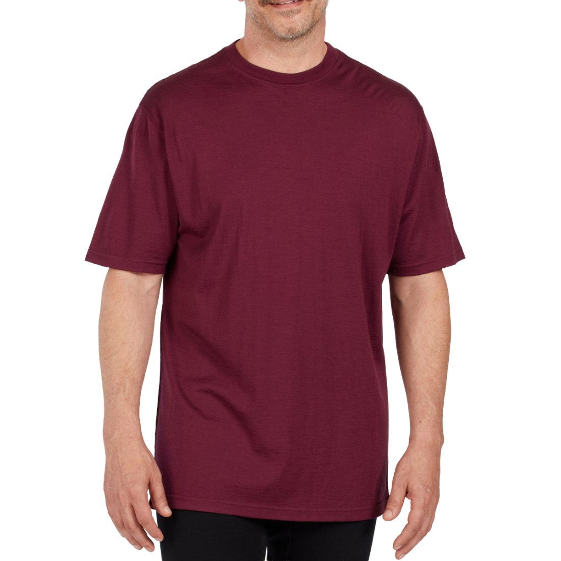 A man wearing a burgundy 100 percent merino wool t shirt shown from the waist up against a solid white background.