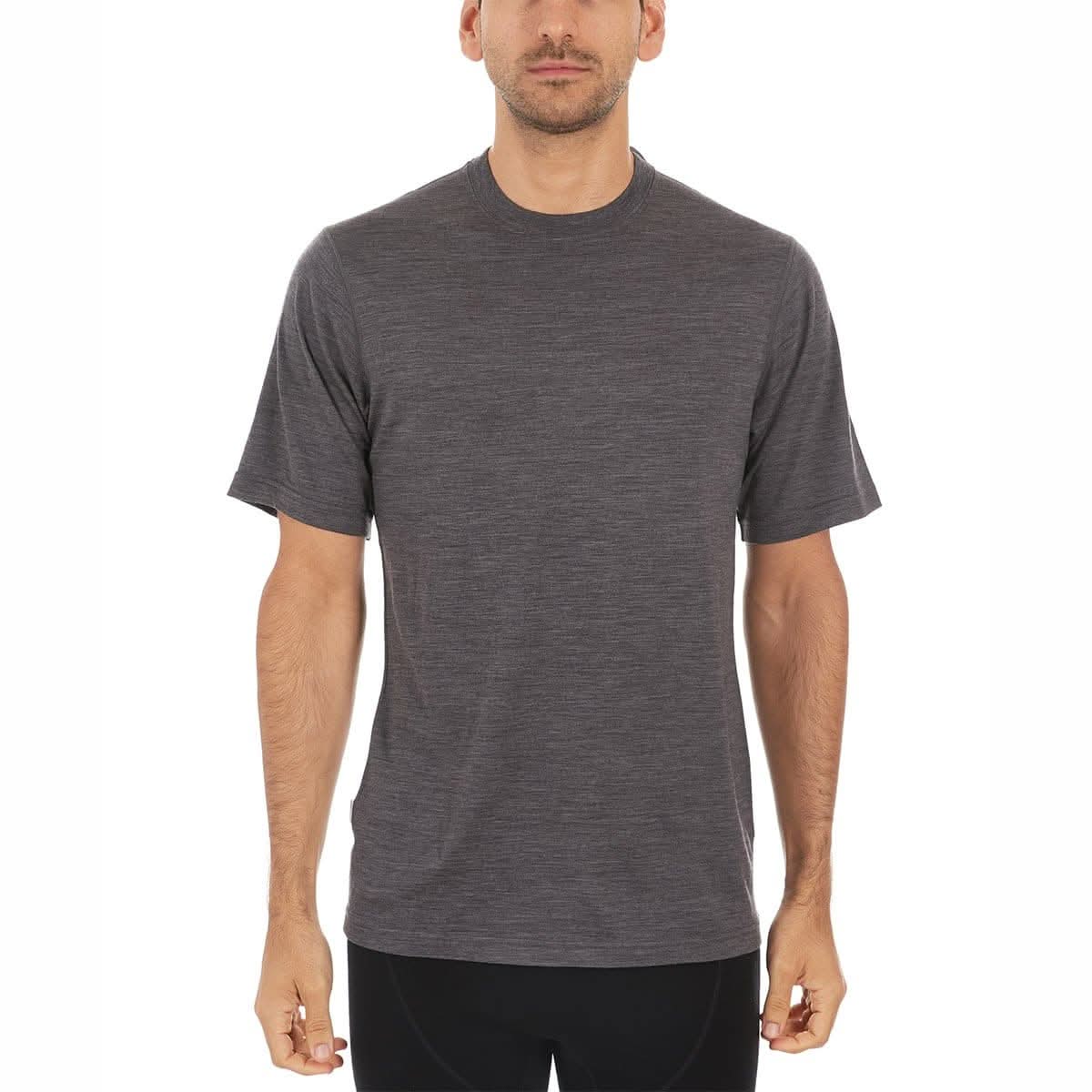 A man wearing a charcoal gray 100 percent merino wool t shirt shown from the waist up against a solid white background.