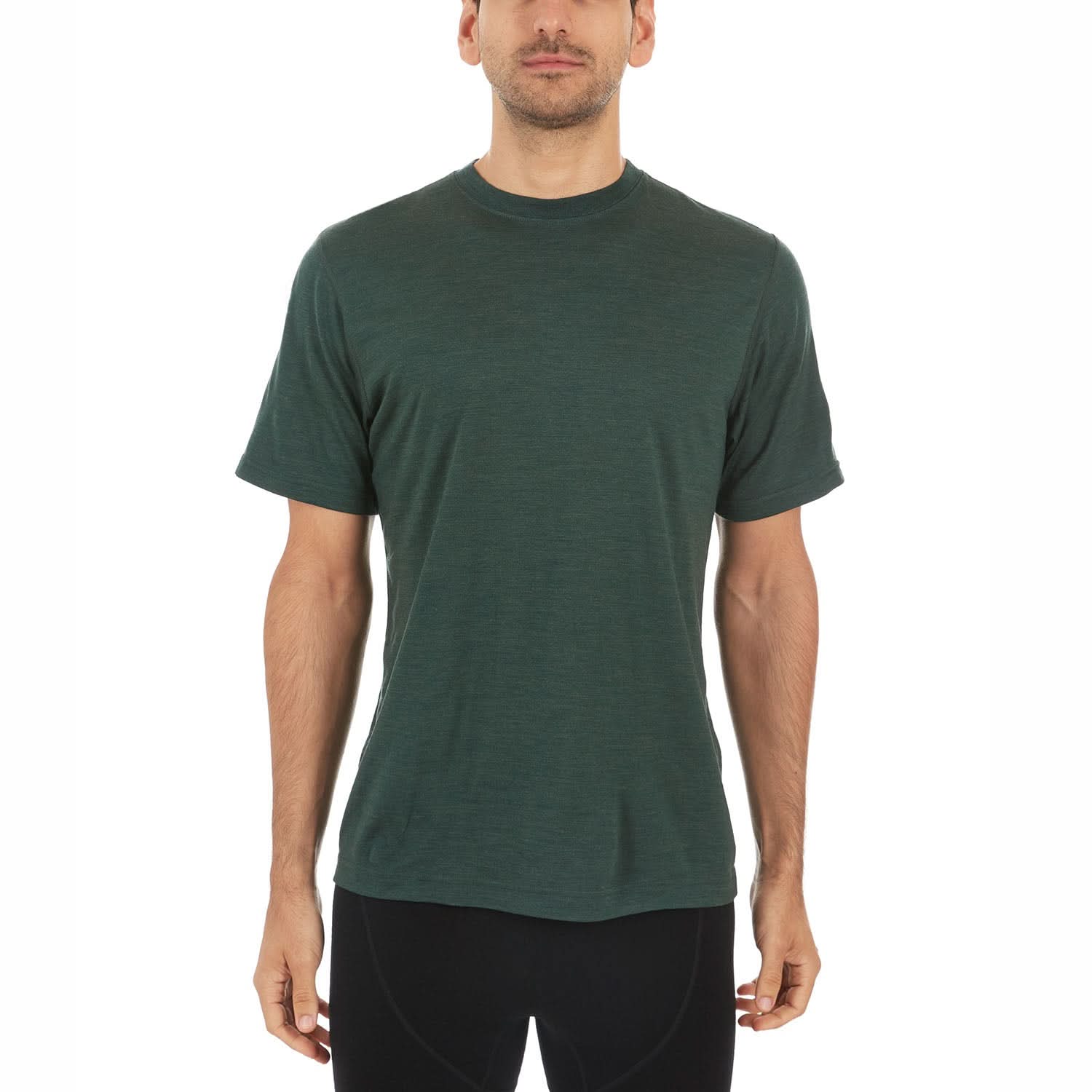 A man wearing a forest green 100 percent merino wool t shirt shown from the waist up against a solid white background.
