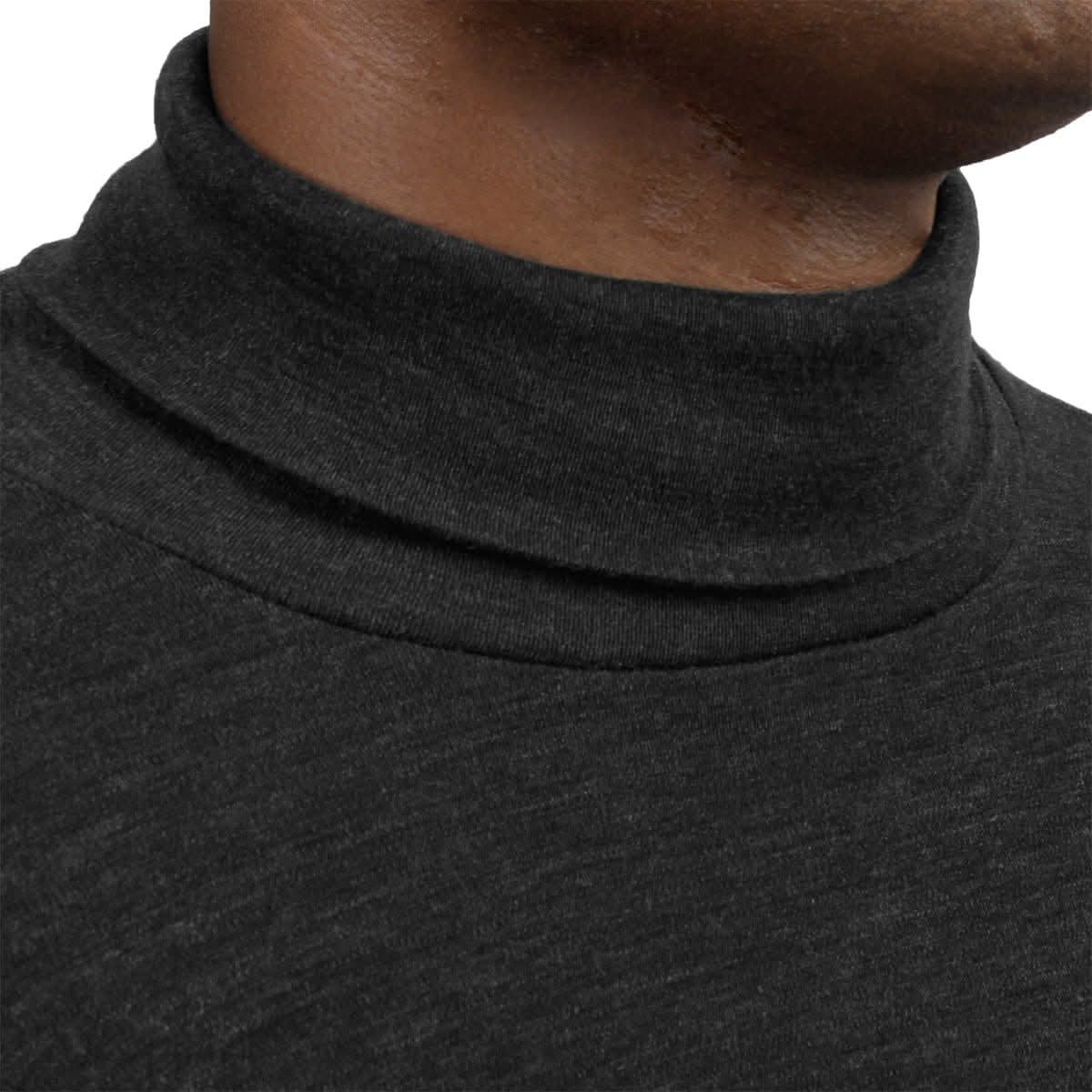 Close-up detail of the folded collar and knit texture on a charcoal grey 100 percent merino wool turtleneck.
