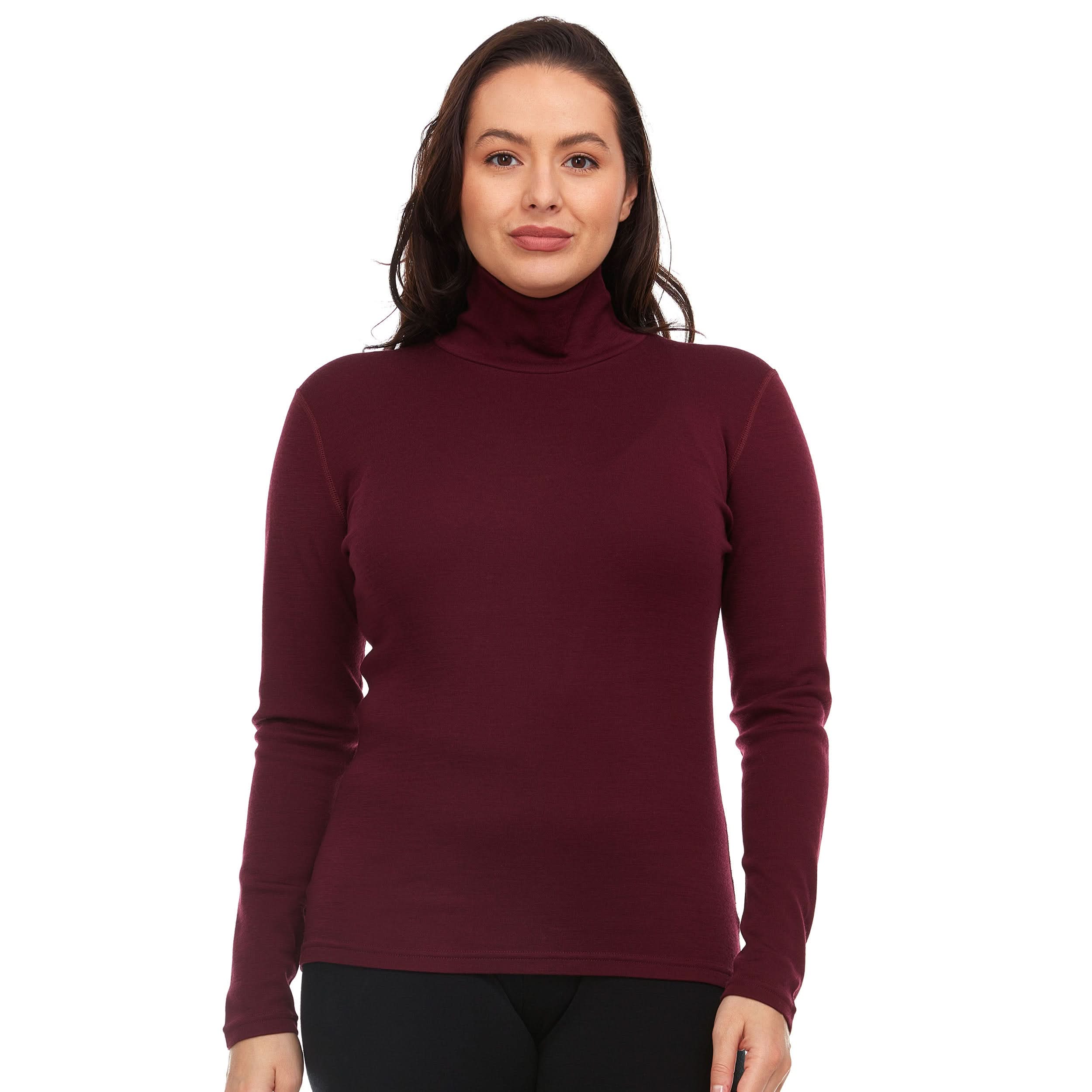 A woman wearing a burgundy 100 percent merino wool turtleneck shown from the waist up against a solid white background.