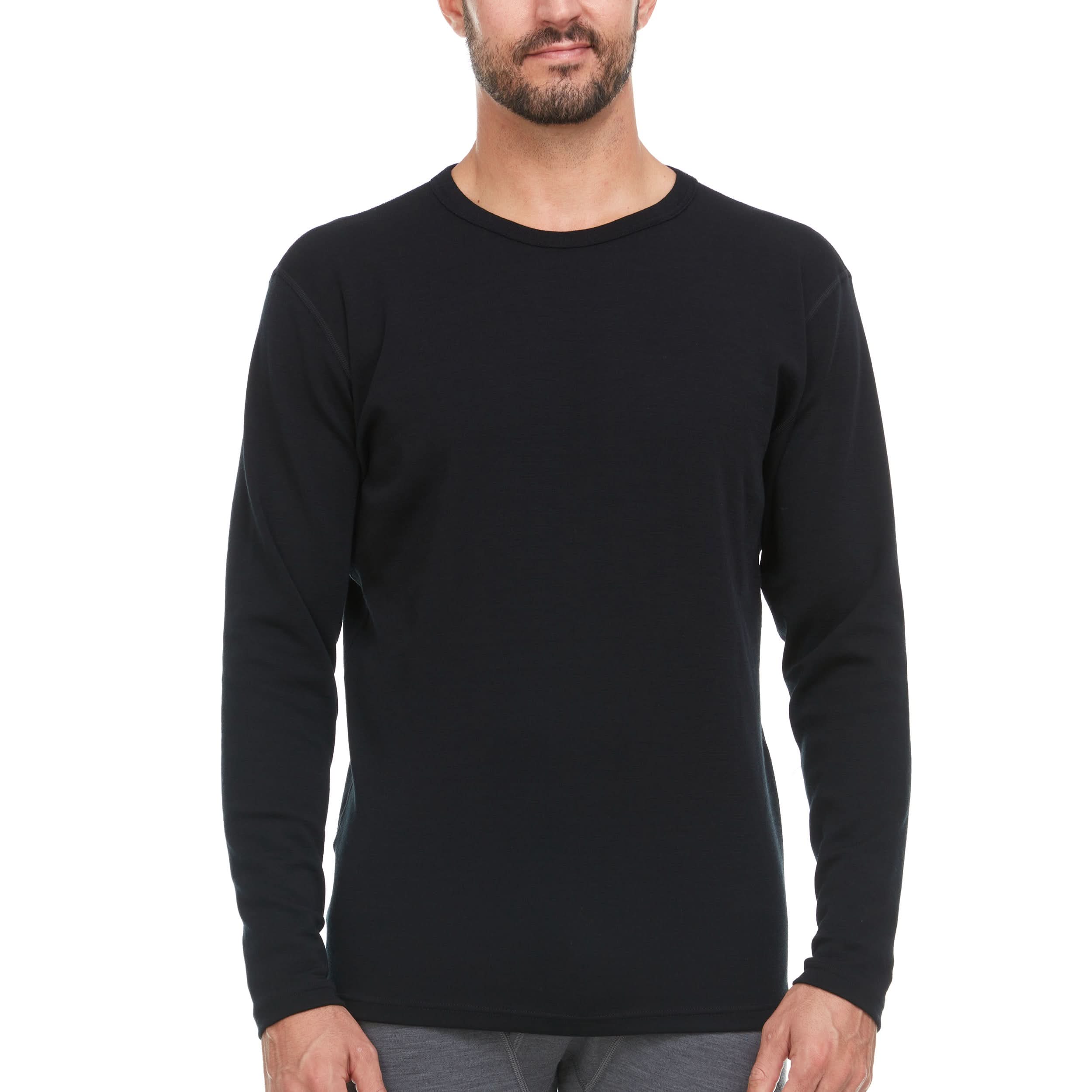 A man wearing a black long-sleeve 100% merino wool base layer top - front view on a white background