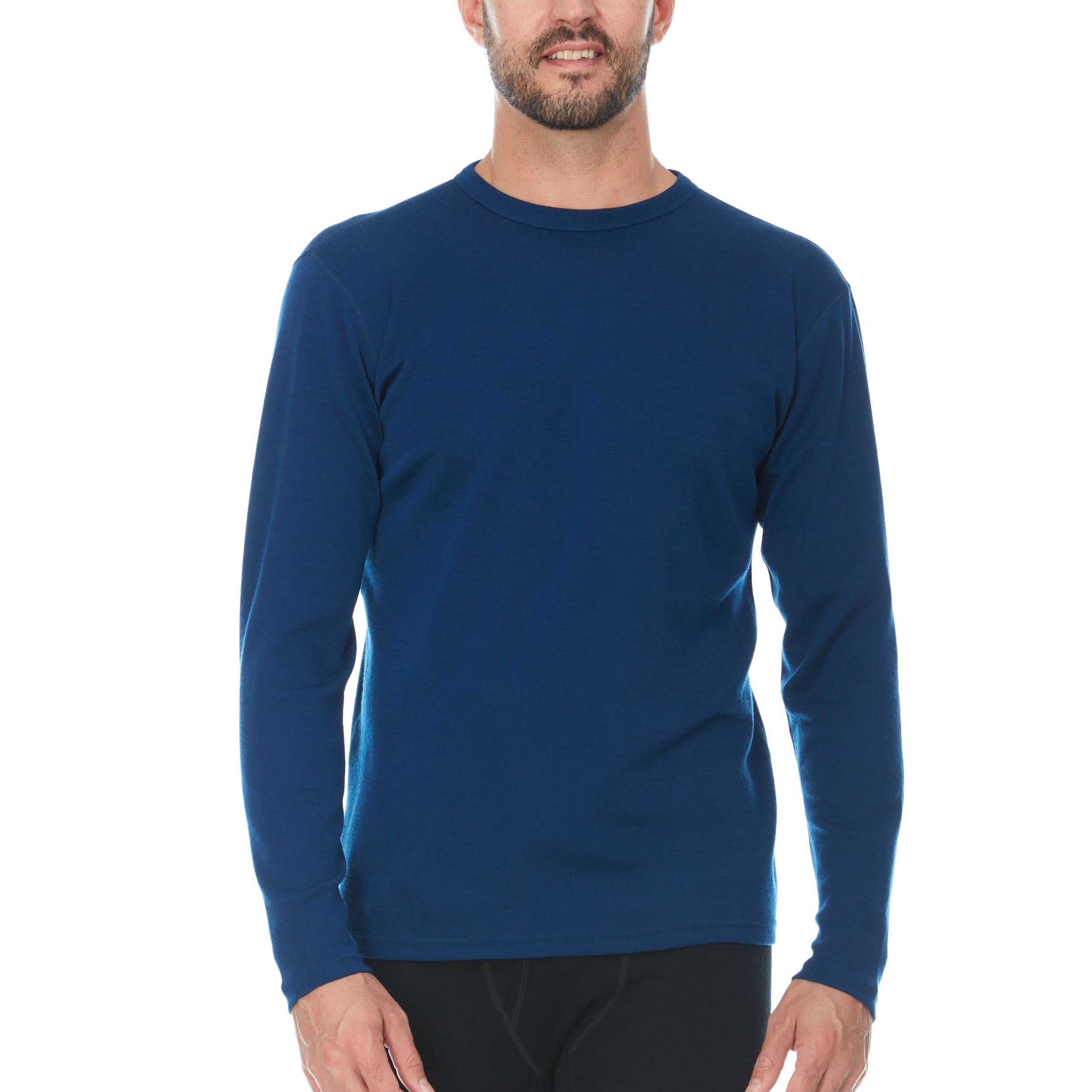 Man wearing a blue long-sleeve 100% merino wool base layer top on a white background