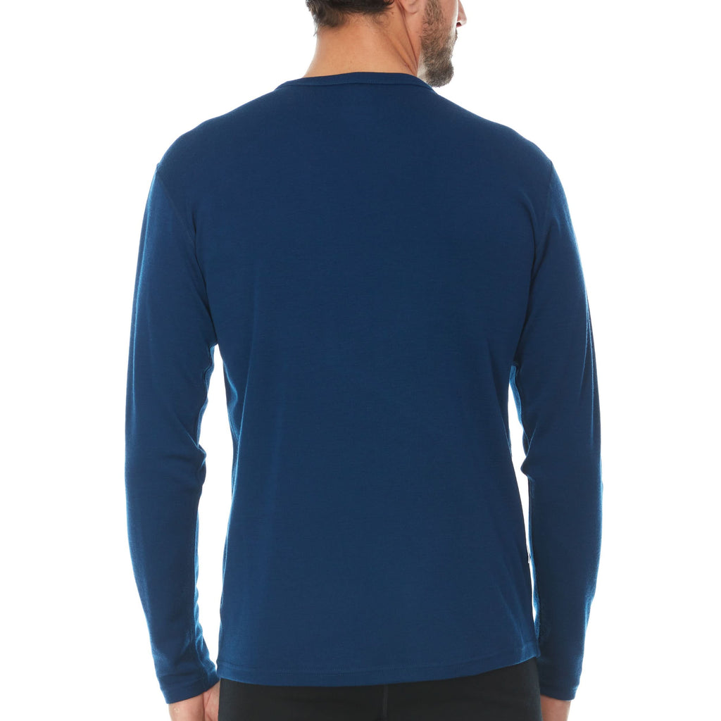Man wearing a blue long-sleeve 100% merino wool base layer top against a white background - rear view