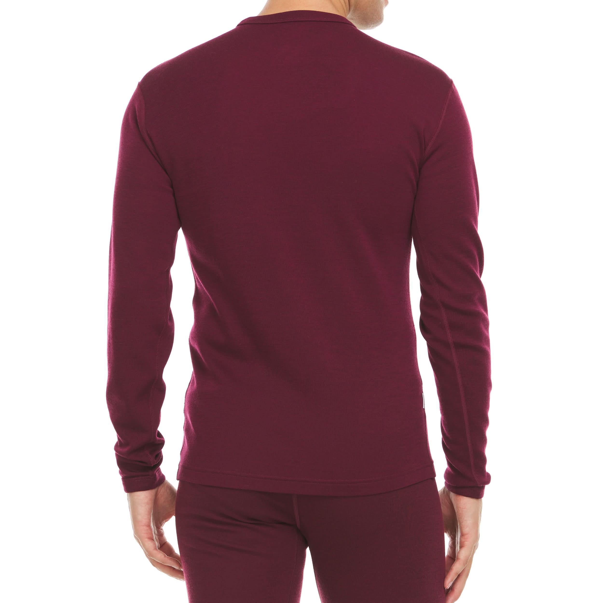 Man wearning a burgundy long-sleeve merino wool base layer top on a white background