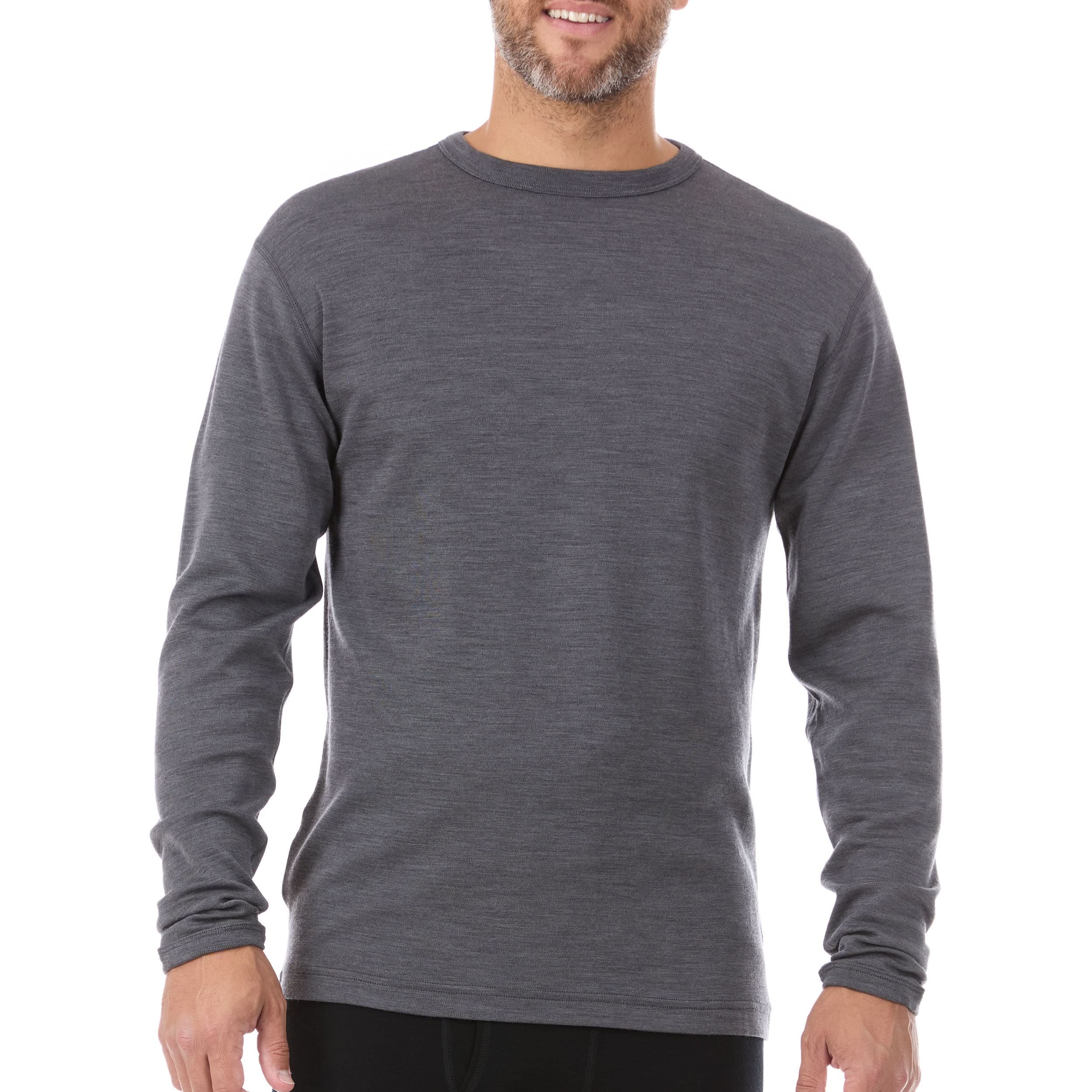 Man wearing a charcoal gray long-sleeve 100% merino wool base layer mens top on a white background