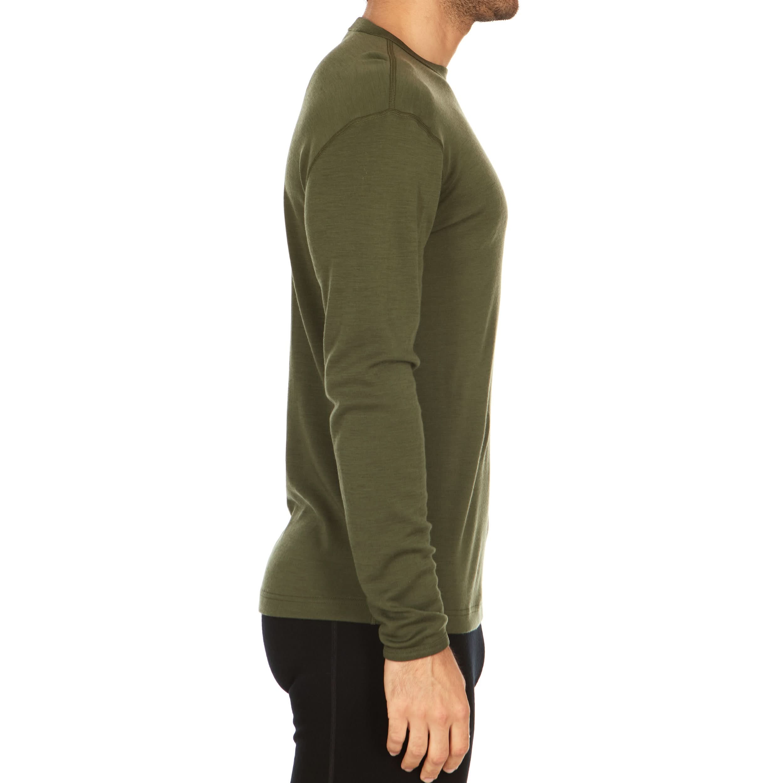 Man wearing a green long-sleeve 100% merino wool base layer top on a white background