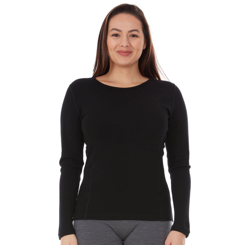 Woman wearing a black long-sleeve princess cut 100 percent merino wool base layer top on a white background