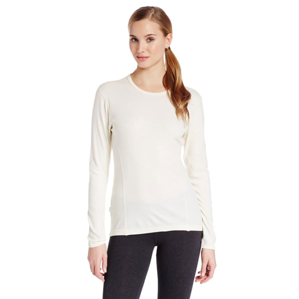 Woman wearing a white 100 percent merino wool basel layer on a white background