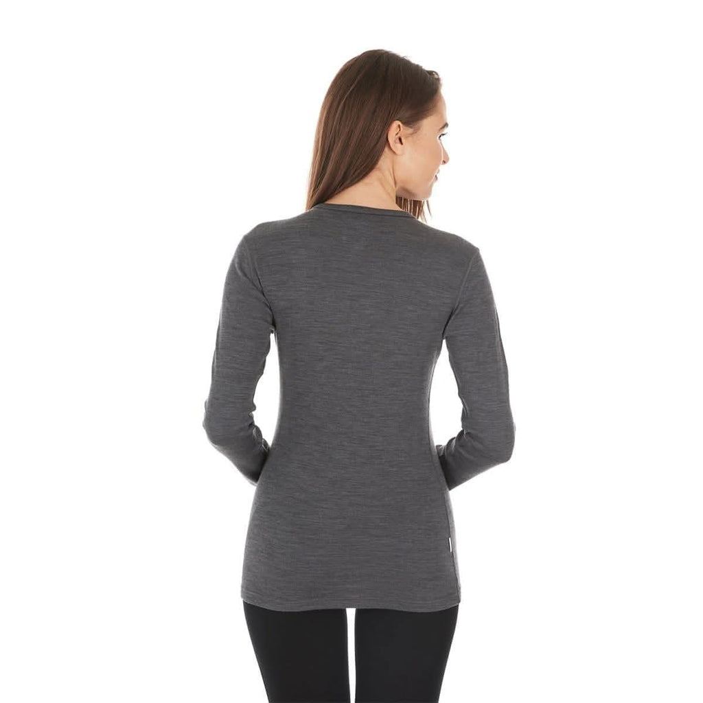 Woman wearing a gray long-sleeve 100 percent merino base layer top on a white background - view from behind