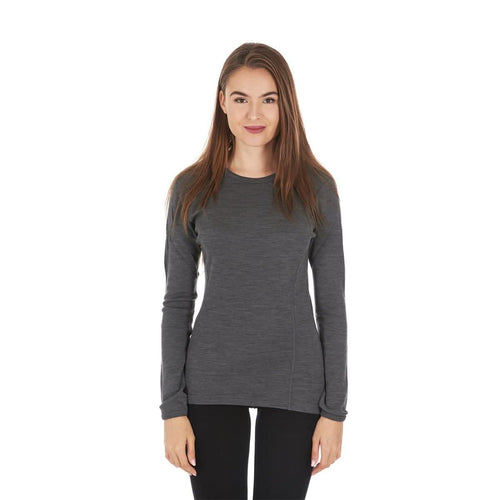 A woman modeling a princess-cut dark gray long-sleeve 100 percent merino wool base layer against a plain white background.