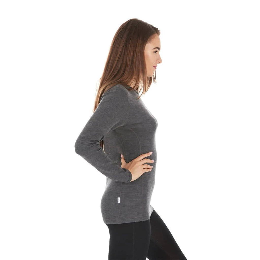 Woman wearing a gray 100 percent  merino base layer top on a white background - side view