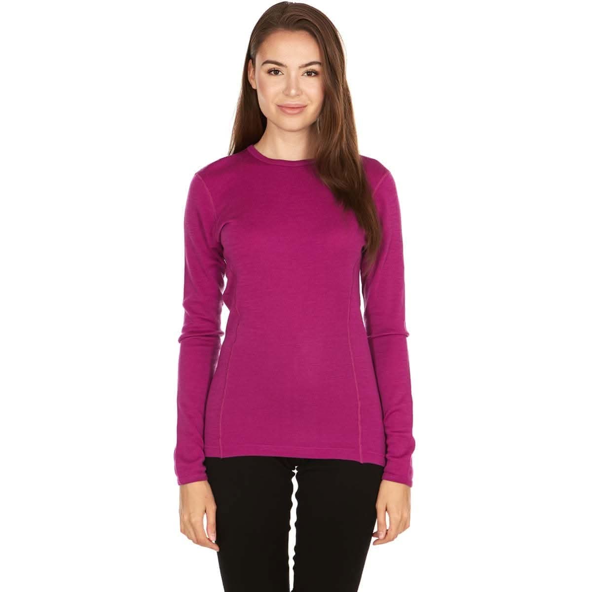 Woman wearing a bright pink midweight long-sleeve 100 percent merino wool base layer top on a white background