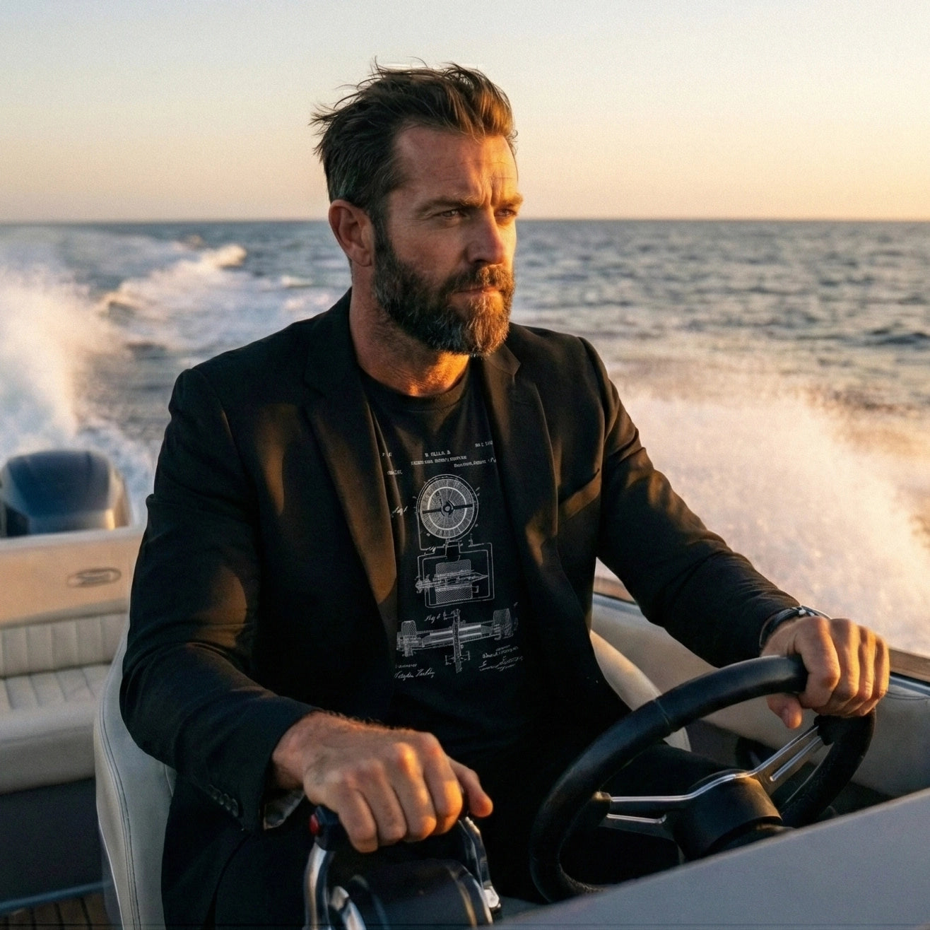 Man driving a speedboat on the water with a sunset background wearing a Nikola Tesla patent printed on a T-shirt under a black blazer