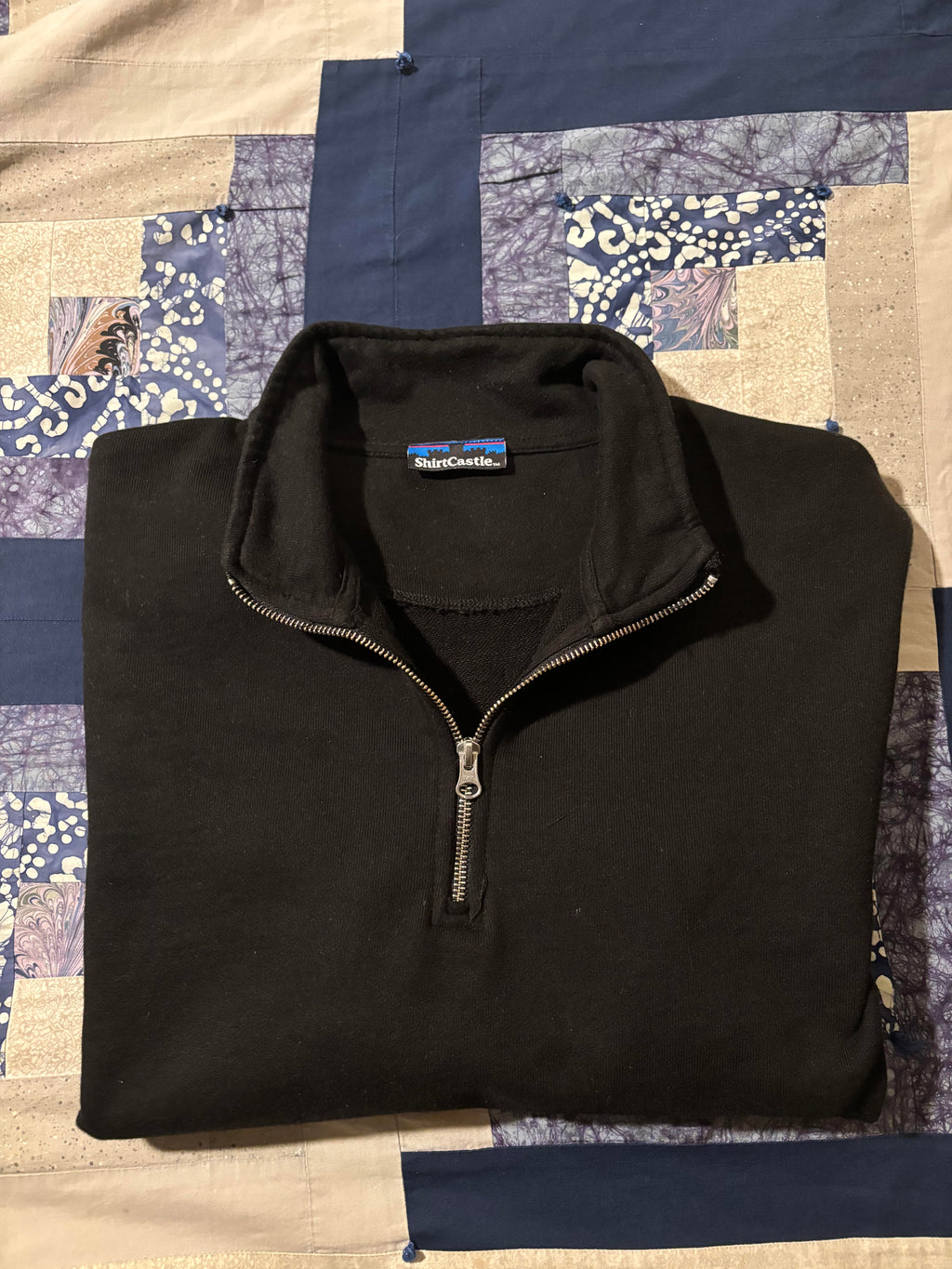 video of amateur folding black 500 gsm organic french terry quarter zip