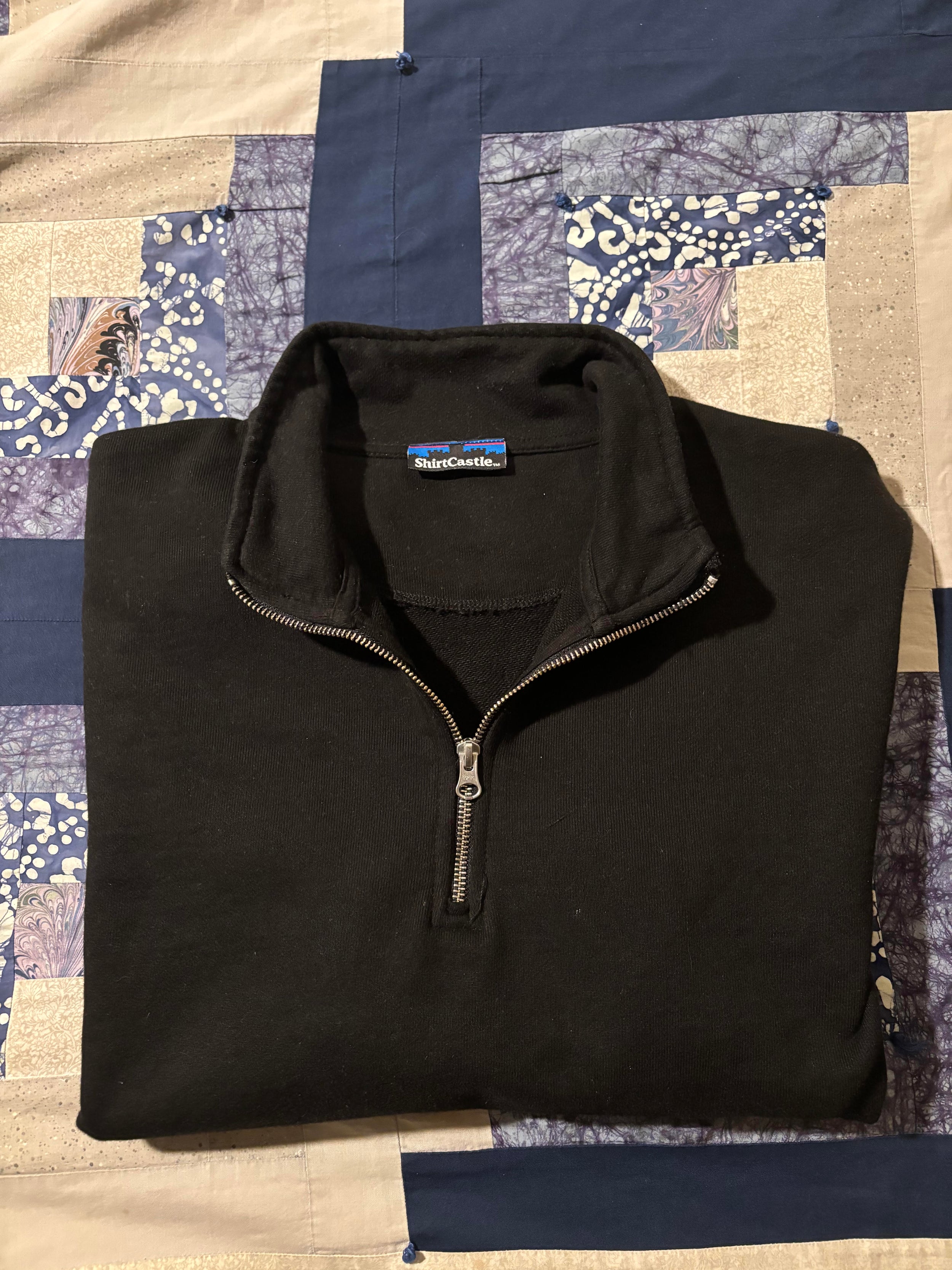 video of amateur folding black 500 gsm organic french terry quarter zip
