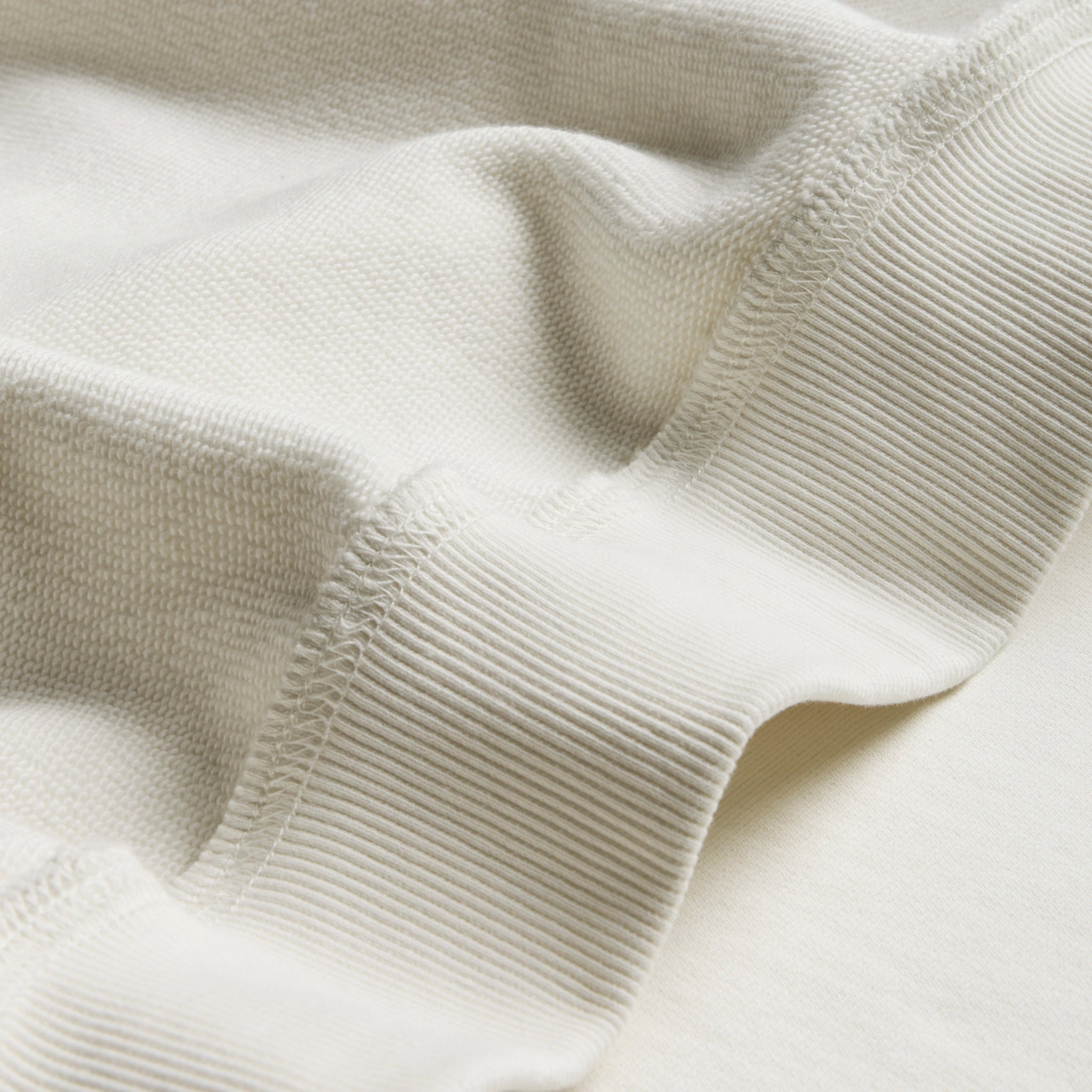 Close-up of a beige knitted fabric texture